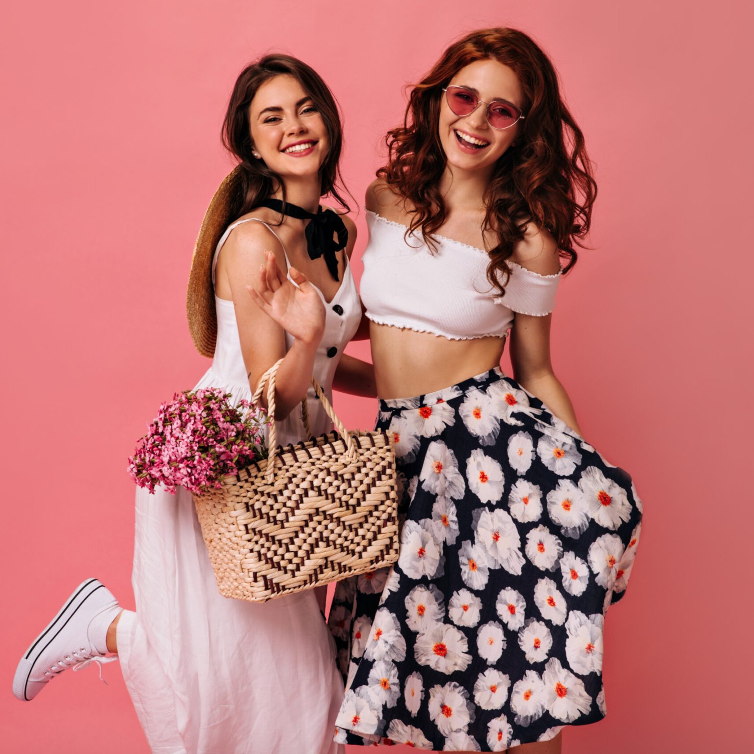 Happy lady in stylish skirt and boater posing on pink background. Young woman in colorful skirt and big hat is very happy on isolated.