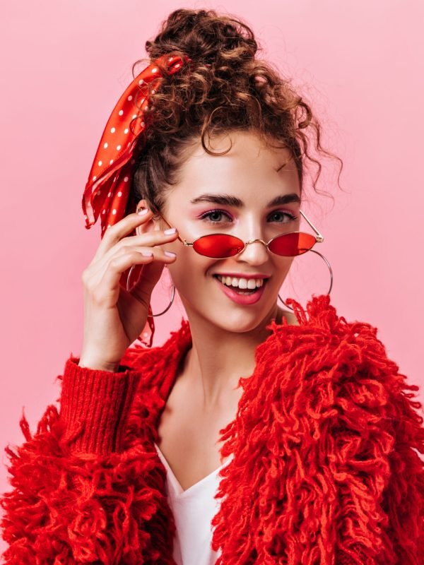 Portrait of pretty lady in red warm jacket and stylish eyeglasses